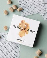 vitruta Simply Gum zencefilli doğal sakız paketi ve yanında serpiştirilmiş sakız parçaları